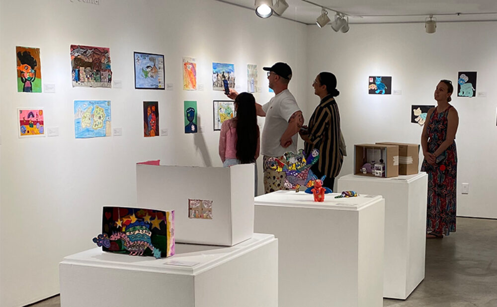 Visitors explore student artwork during the opening reception of Imagine This: LBUSD Elementary Exhibition at LBMA Ocean.