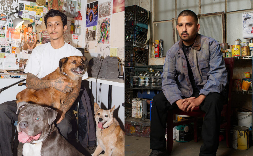 A split portrait of two artists in their workspaces. On the left, Mario Ayala, sits in a studio filled with posters, drawings, and colorful artwork, holding a brown dog on his lap while a gray dog sit in the foreground and a tan dog sit by Mario's side. On the right, Alfonso Gonzalez Jr. sits on a stool in an industrial studio, wearing a blue paint-marked work jacket, with spray paint cans, stacked milk crates, and art materials behind him.