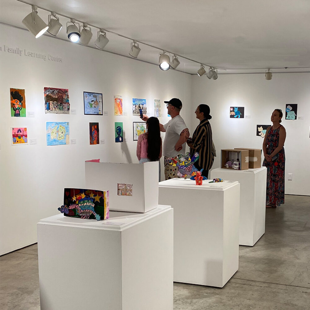 Visitors explore student artwork during the opening reception of Imagine This: LBUSD Elementary Exhibition at LBMA Downtown.