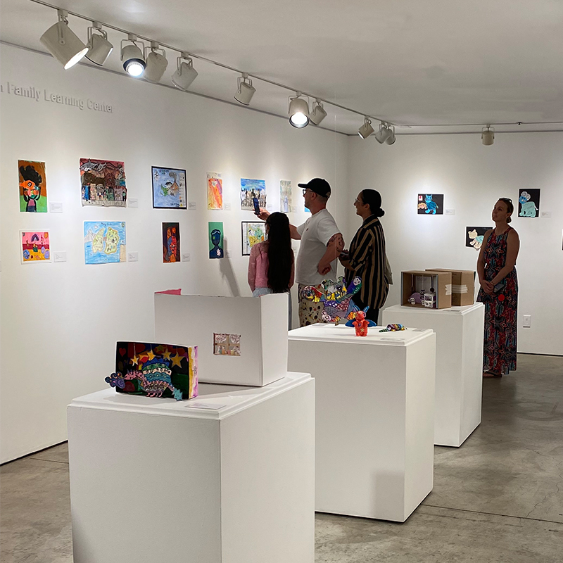 Visitors explore student artwork during the opening reception of Imagine This: LBUSD Elementary Exhibition at LBMA Downtown.